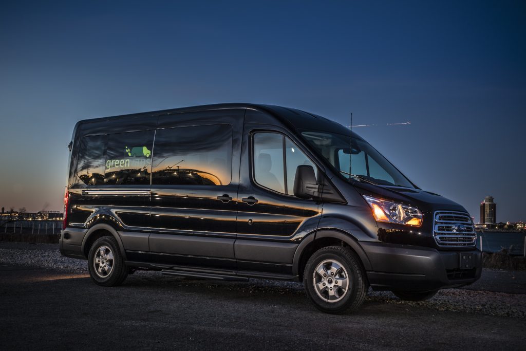 Black Ford 15 Passenger Mid Roof Transit Van with Greenvans logo