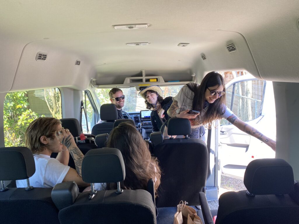 Interior view of Greenvans Ford 15 passenger transit van with five passengers inside