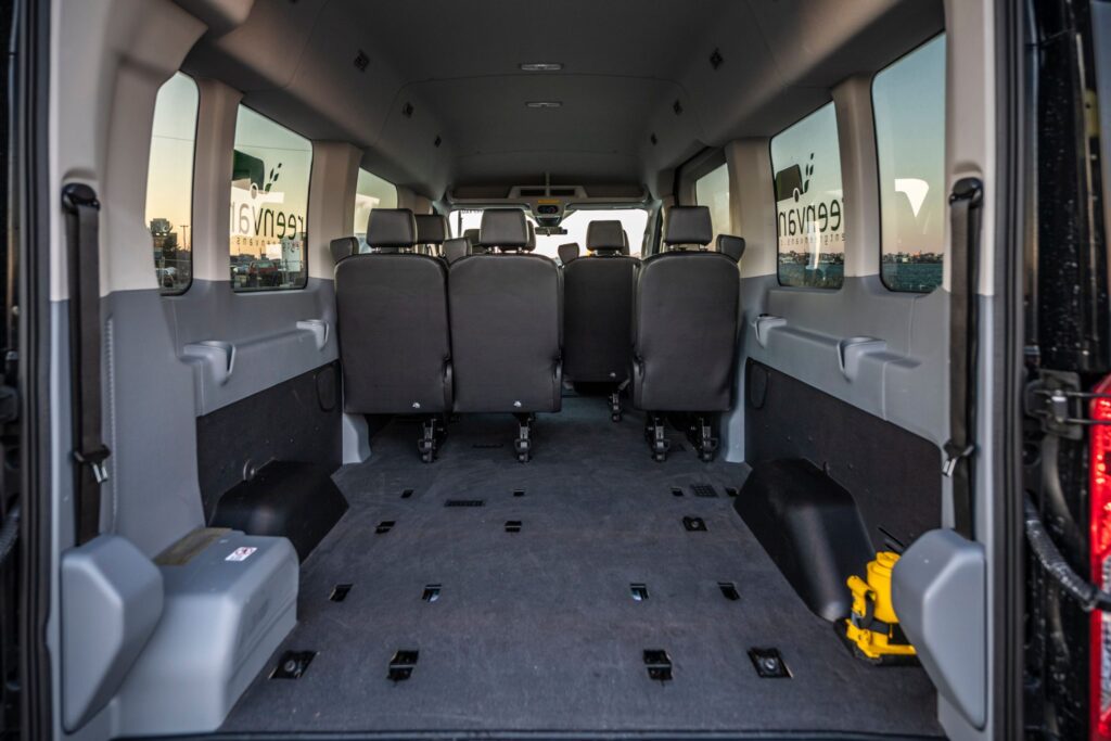 Rear Interior view of 15 passenger van with seats removed to demonstrate luggage space of Greenvans rental vans