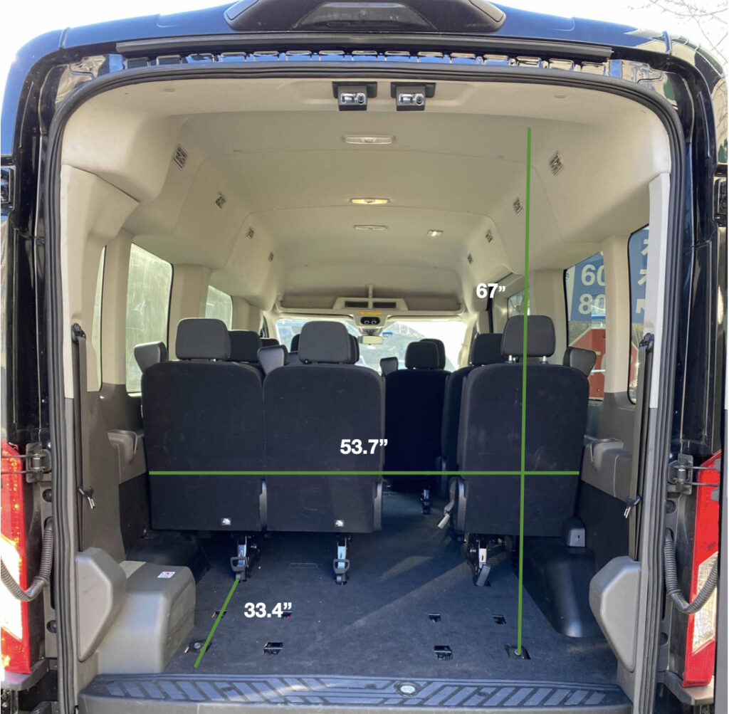 Interior view of 15 passenger transit van with back row removed to demonstrate luggage space