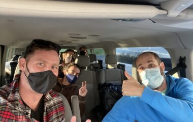 Andy and Anthony with team wearing masks sitting in a Ford 15 passenger transit van