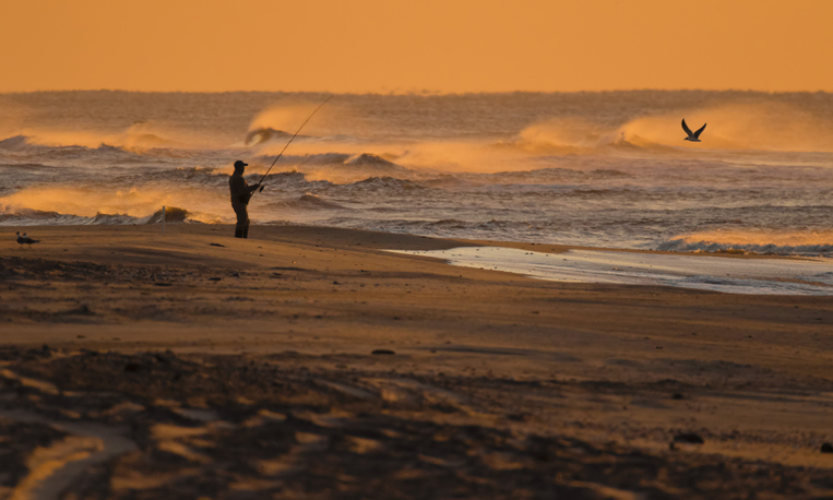 Fisherman on Portsmouth Island shortly after sunrise