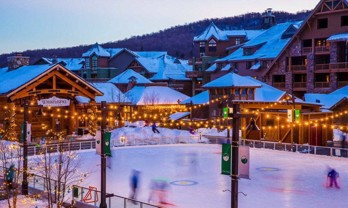 Outside view of Stowe Mountain Resort with hockey rink and Whistling Pig