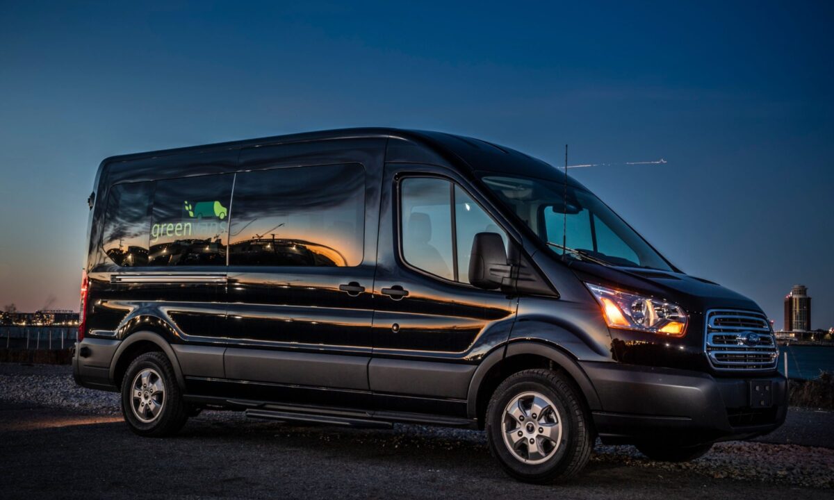 Side image of a Greenvans 15 passenger van Ford Transit 350 XLT with Greenvans logo