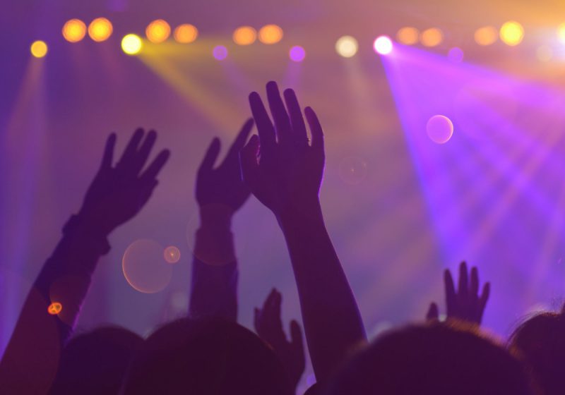hands waving in the air at a concert