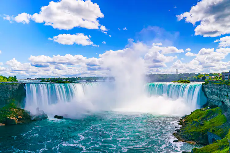 Niagara Falls with blue sky and clouds in background