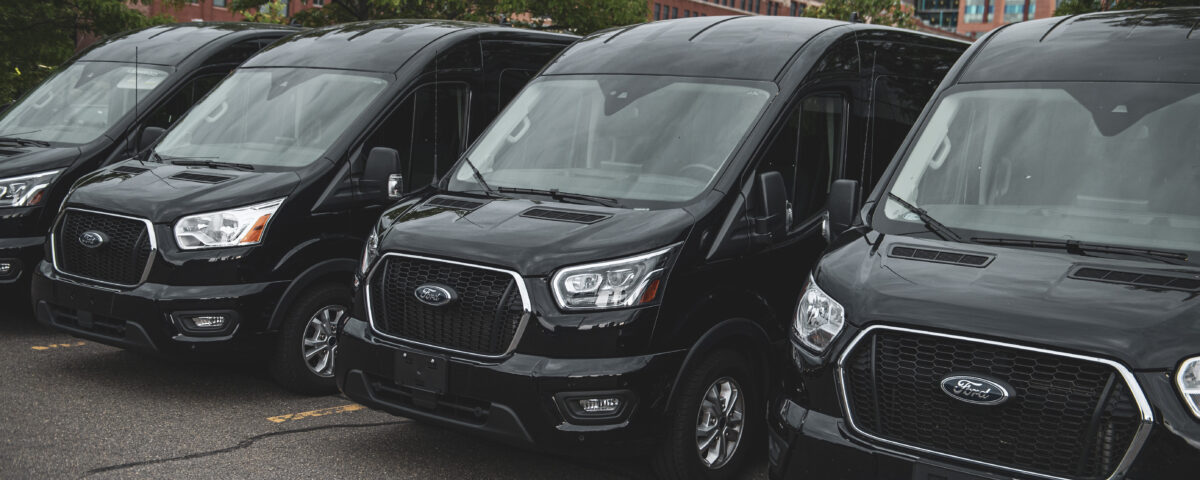 Side view of Ford 15 Passenger Medium Roof Transit passenger van rental