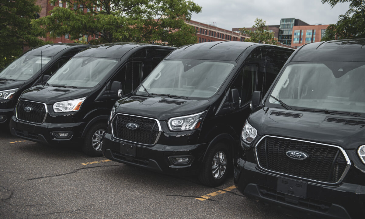 Side view of Ford 15 Passenger Medium Roof Transit passenger van rental