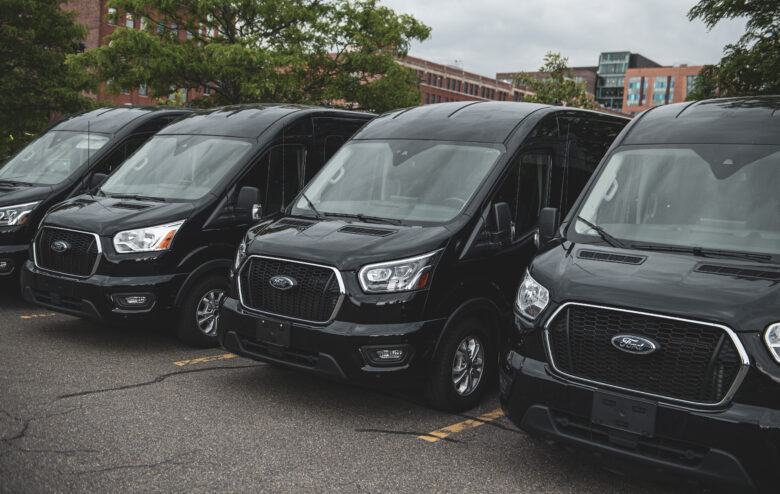 Side view of Ford 15 Passenger Medium Roof Transit passenger van rental