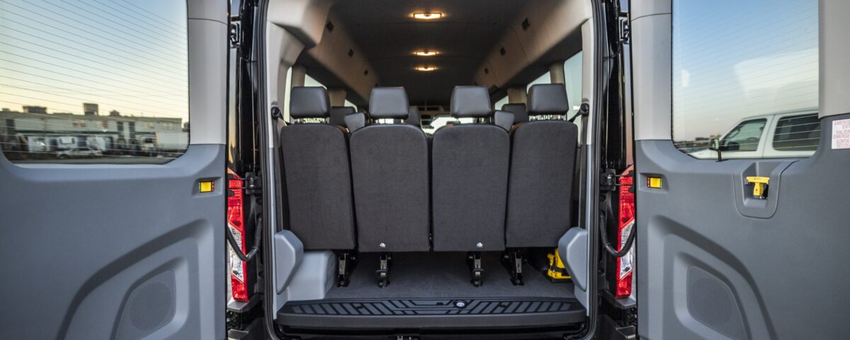 Back interior view of Ford 15 Passenger Medium Roof Transit 350 XLT with all four rows installed