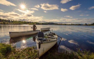 A man prepares to do some fishing in a small boat on a lake